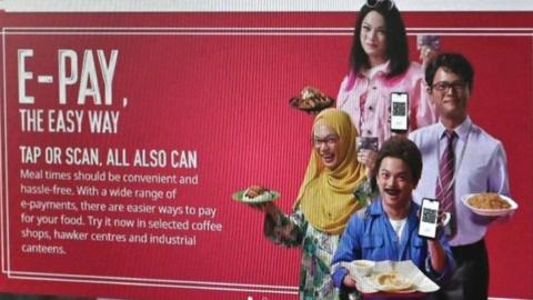 The Nets e-pay advert showing actor Dennis Chew in dark make up, dressed as an Indian man and a Malaysian woman in a hijab