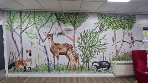 One of the walls at the hospital which now features a forest scene complete with deer, a fox and a badger as well as trees and plants. 