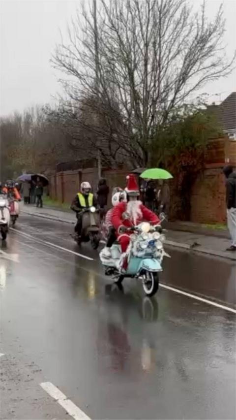 A motorbike rider dressed as Santa, driving through Early.