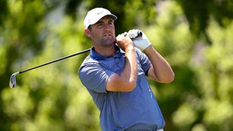 Scottie Scheffler watches his shot