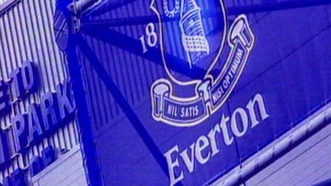 Everton's crest on a banner on a stadium