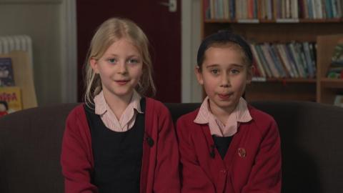 Two girls sat in school