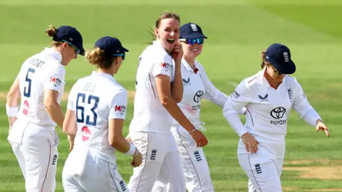 England's Lauren Filer looks surprised as she dismisses India's Richa Ghosh