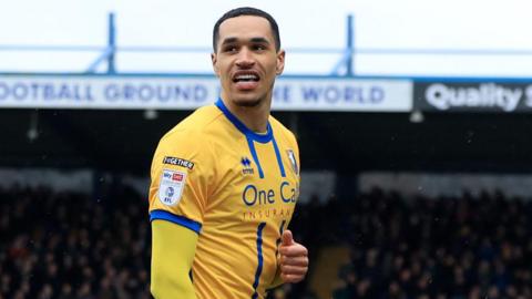 Jon Russell smiles after scoring for Mansfield against AFC Wimbledon