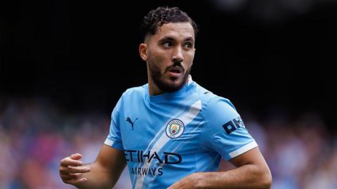 Rayan Cherki in Manchester City home kit