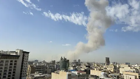 smoke rises in tehran
