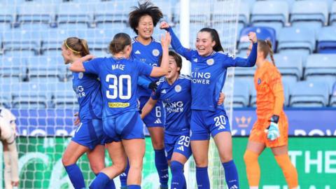 Leicester City players celebrate scoring against Chelsea