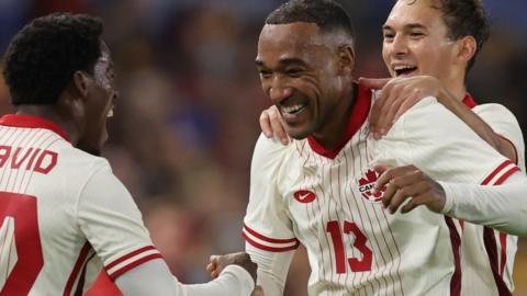 Canada's Derek Cornelius (R) celebrates with team-mate Jonathan David