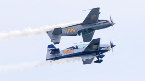 Starlings display team performing a formation stunt with one of the aircraft flying inverted above the other