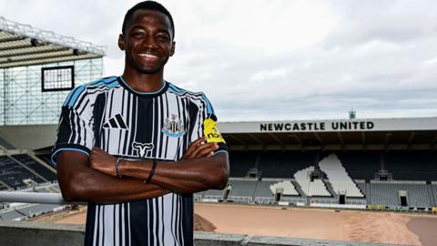 Bazoumana Toure poses for photographs at St James' Park