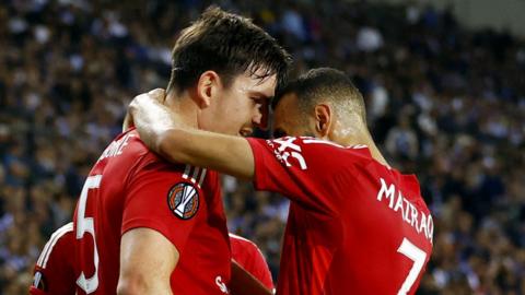 Manchester United's Harry Maguire celebrates his equalising goal at Porto with Noussair Mazraoui