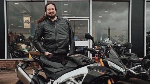 Joe Parry stood by his motorbike