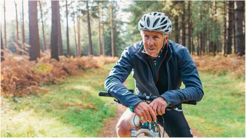 Pensioner on bike in forest