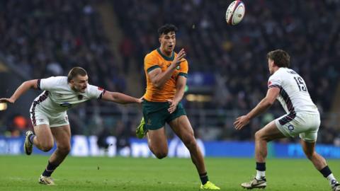 Joseph-Aukuso Suaalii passes the ball over George Furbank