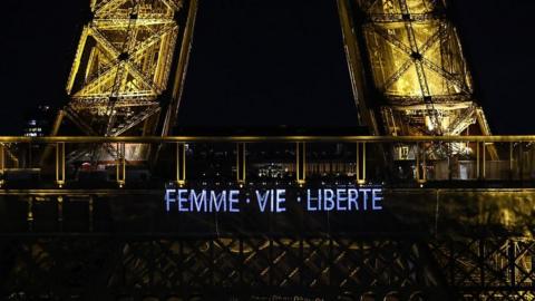 Eiffel Tower with the words "Femme, Vie, Liberte"