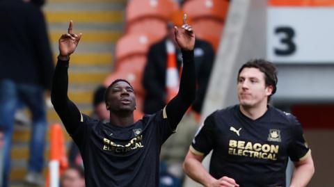 Bim Pepple celebrating after scoring for Plymouth Argyle next to teammate Alex Mitchell.