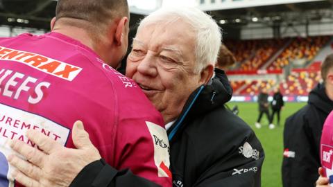 Exeter chief executive Tony Rowe hugs a player