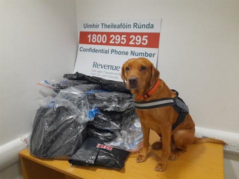 Dog next to pile of drugs in bags