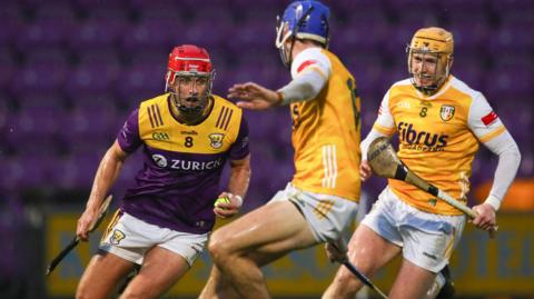Wexford's Conor Hearne takes on the Antrim defence