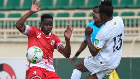 Kenya's Erick Otieno (left) fights for the ball with Uganda's Milton Karisa (right)