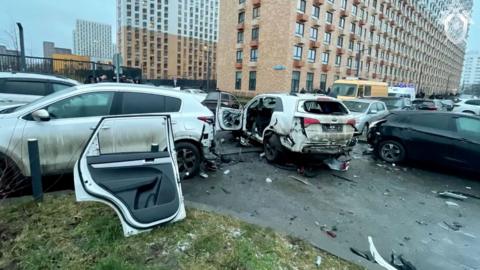 Members of emergency services and investigators work at the scene where Lieutenant General Fanil Sarvarov, head of the Russian General Staff's army operational training directorate, was reportedly killed in a car bomb in Moscow