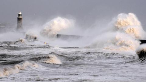 Large waves crashing against Tynemouth piers at Tynemouth beach.