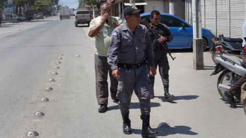 Mynor Padilla (left), walks down the street during his first trial on 17 May 2016