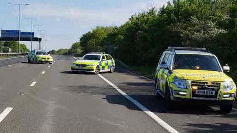 Three police cars on the M11, Essex