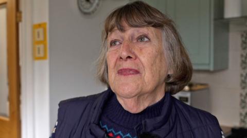 Penny Harcourt at home wearing a black top.