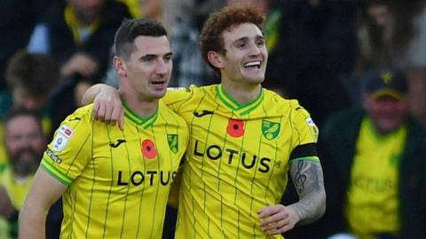 Josh Sargent with his right arm round the shoulder of Kenny McLean as they celebrate a Norwich goal in 2024