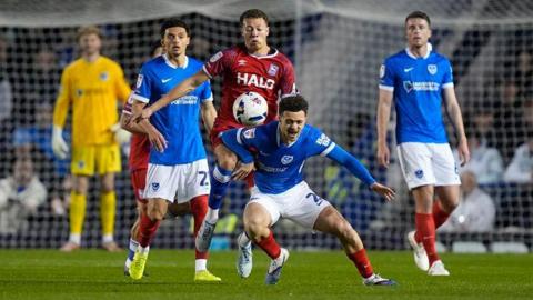 Ipswich's Kasey McAteer bundles over Portsmouth's Jordan Williams