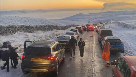 Lots of parked cars on a country lane in Derbyshire 