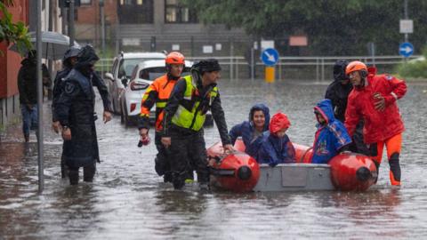 Firefighters evacuating people near Milan 