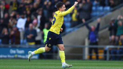 Tyler Goodrham scores for Oxford against Millwall