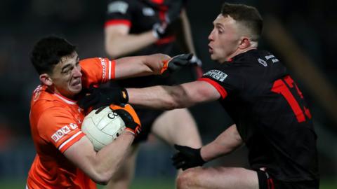 Armagh's Rory Grugan attempts to fend off Louth's Ryan Burns