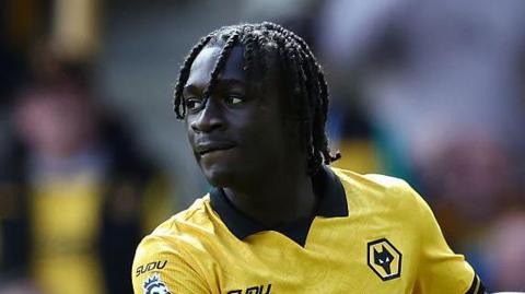 Mateus Mane during a match in a Wolves old gold shirt