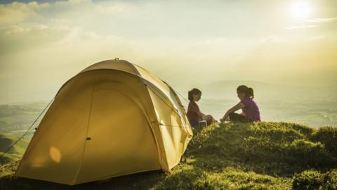 Girls outside tent