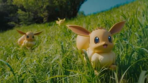 a picture of some Eevee statues in some grass