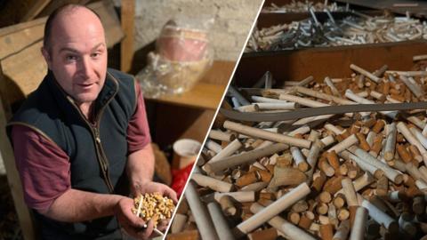A man with short dark hair holding cigarette butts in an attic. He is wearing a black gilet and burgundy top. Split with loft scene of cigarettes in between wood beams. 