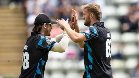 Rob Jones of Worcestershire Rapids (left) congratulates bowler Adam Finch on taking the wicket of David Willey of Northamptonshire Steelbacks (not shown) during the Vitality Blast T20 match between Worcestershire Rapids and Northamptonshire Steelbacks