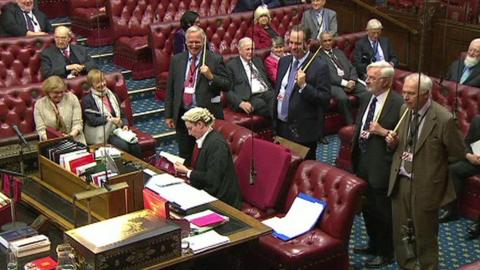 A clerk consults standing orders as peers await the result of the Wales Bill vote.