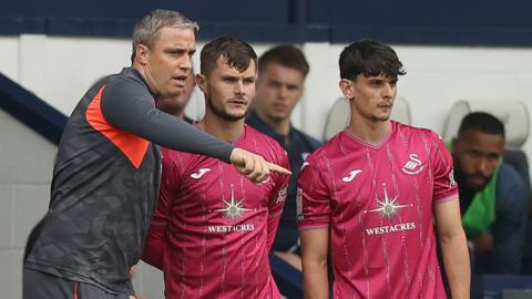 Head Coach Michael Duff of Swansea gives instructions to subs Liam Cullen of Swansea and Charlie Patino of Swansea