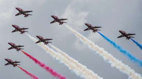 Red Arrows in flight with smoke trails