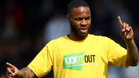 Raheem Sterling of Manchester City warms up while wearing a Kick It Out racism shirt