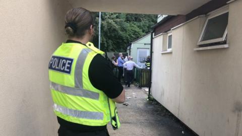 Police at scene of house after fire