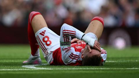 Martin Odegaard of Arsenal goes down with an injury
