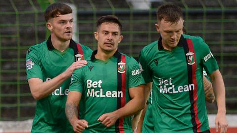 Jordan Stewart is congratulated by Glentoran team-mates