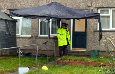 police office under tent at murder scene