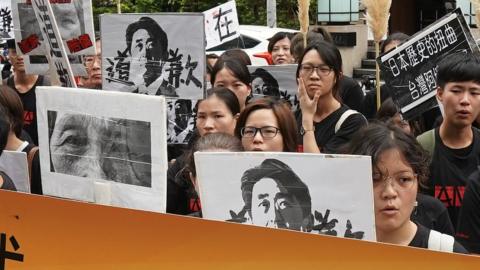 59 people from women's rescue foundation sit-in to protest against Japanese government by wearing black T-shirt and white mask at World comfort women's day on 14 August 2018 in Taipei city