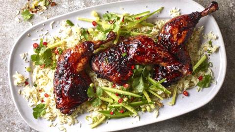 Honey soy glazed chicken on a bed of greens and rice